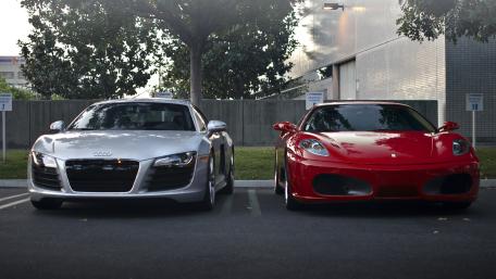 Audi R8 and Red Ferrari Supercars Parked in Urban Shadowed Light wallpaper