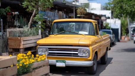 Vintage Yellow Pickup on Sunny Street wallpaper