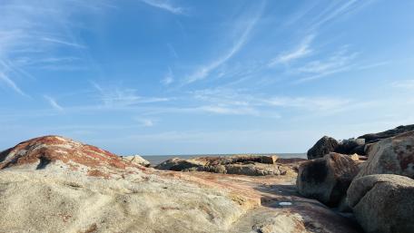Sunlit Coastal Boulders in Bang Pahang wallpaper