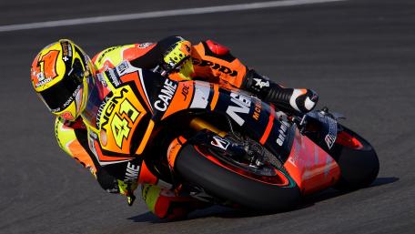 MotoGP Racer Leaning Into High Speed Corner wallpaper