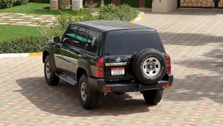 Classic Nissan Patrol SUV in Sunlit Driveway wallpaper