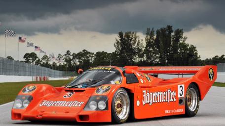 Orange Racing Beast on Stormy Track wallpaper