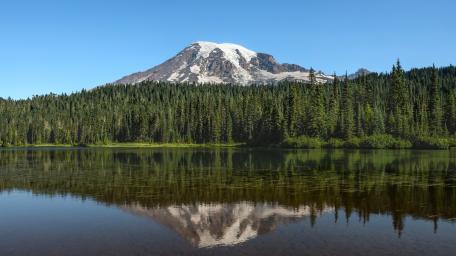 Snowy Peak Reflection Over Forest Lake wallpaper