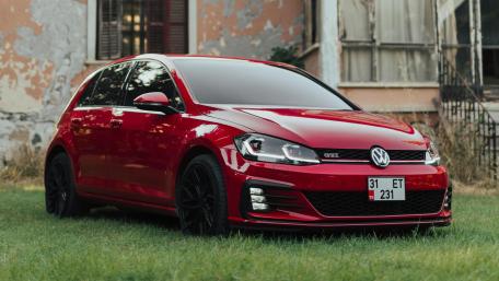 Red Volkswagen GTI in Urban Retro Setting wallpaper