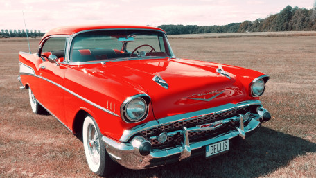 Classic Red Chevrolet Bel Air on Open Field wallpaper