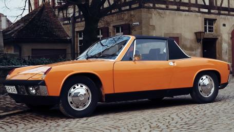Classic Orange Porsche 914 on Cobblestone Street wallpaper