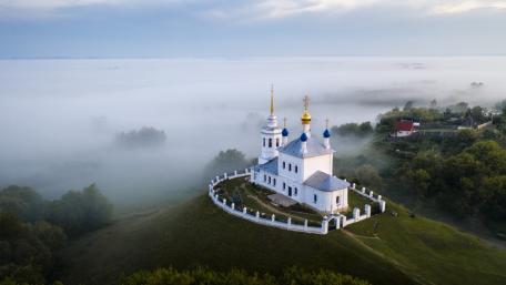 Misty Hilltop Chapel Above the Clouds wallpaper
