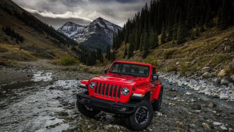 Red Jeep Wrangler in Rugged Mountain River Landscape wallpaper
