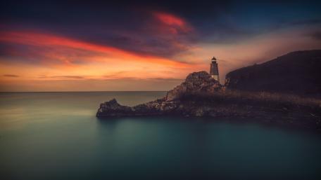 Twilight Lighthouse Over Calm Horizon wallpaper