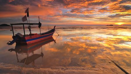 Golden Sunset Fishing Boat on Calm Lake wallpaper