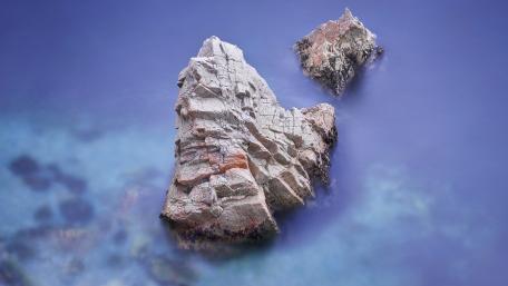 Tranquil Ocean Rocks Over Blue Waters wallpaper