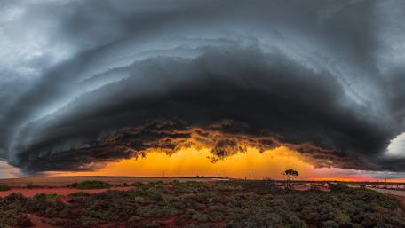 Inferno Beneath Storm Clouds wallpaper
