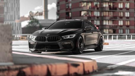 Sleek Black BMW M8 in City Light wallpaper