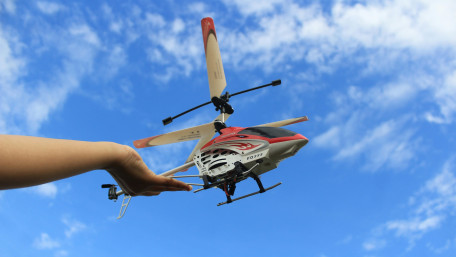 Handheld RC Helicopter in Blue Sky wallpaper