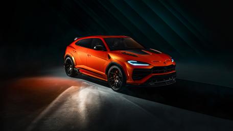 Orange Lamborghini Urus in Dramatic Studio Light wallpaper