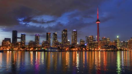 Toronto Skyline Glowing Over Lake Ontario wallpaper