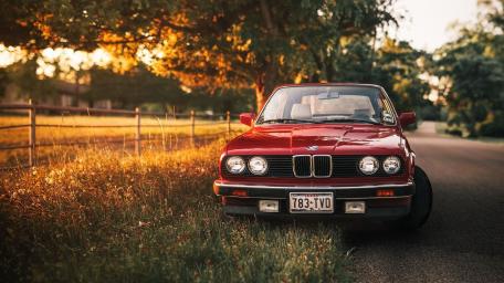 Classic Red BMW on Golden Country Road wallpaper