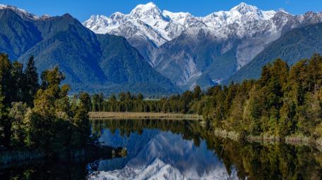 Mirror Waters Beneath Snowy Peaks wallpaper