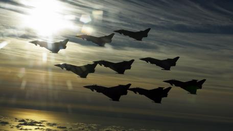 Golden Typhoon Squadron Over Cloudy Skies wallpaper