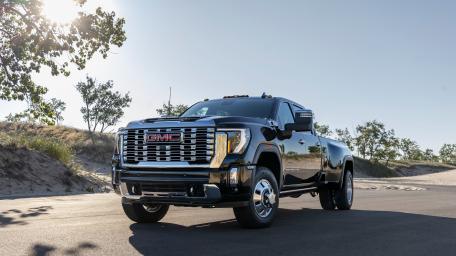 Bold GMC Sierra on Sunlit Road wallpaper