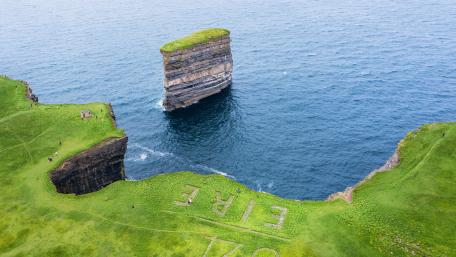 Dún Briste Rising Over Ireland’s Wild Coast wallpaper