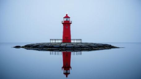 Silent Red Lighthouse on Calm Waters wallpaper