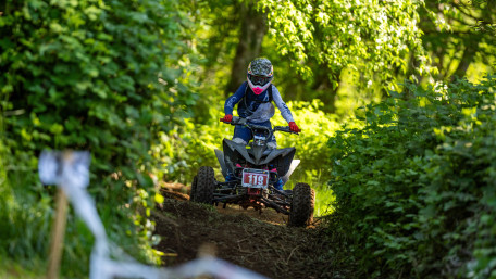 Forest Quad Rider Charging Through Trail wallpaper
