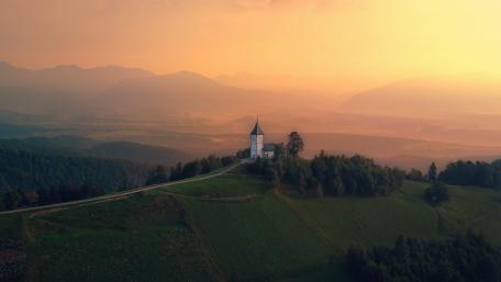 Misty Sunrise Over Jamnik Hilltop Church wallpaper