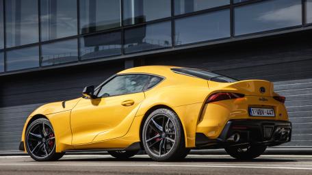Yellow Toyota GR Supra on Urban Street wallpaper