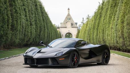 Matte Black Ferrari LaFerrari on Elegant Driveway wallpaper