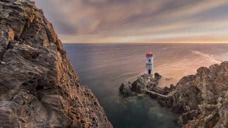 Capo Ferro Lighthouse Above the Sardinian Sea wallpaper