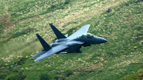 Fighter Jet Over Mountain Valley wallpaper