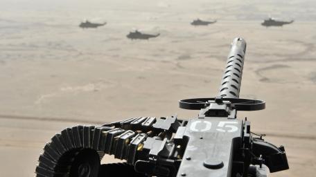 Military Machine Gun Over Desert Skies wallpaper