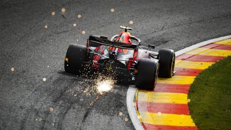 Blazing Formula One Cornering Action wallpaper