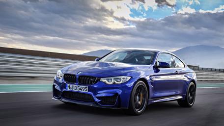 BMW M4 Racing Through Open Road wallpaper