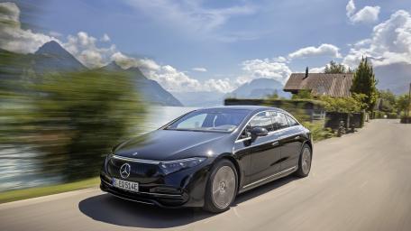 Sleek Mercedes-Benz EQS Cruising Lakeside Road wallpaper