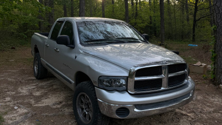 Forest Parked Dodge Ram Under Soft Sunlight wallpaper