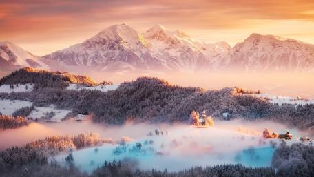 Alpine Dawn Over Snowy Chapel wallpaper