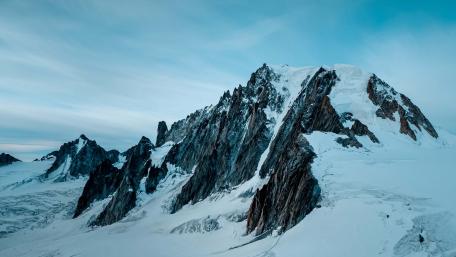 Snowcapped Peaks Under Winter Sky wallpaper