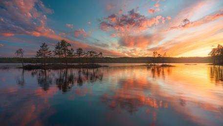 Sunset Glow Over Calm Lake Islets wallpaper