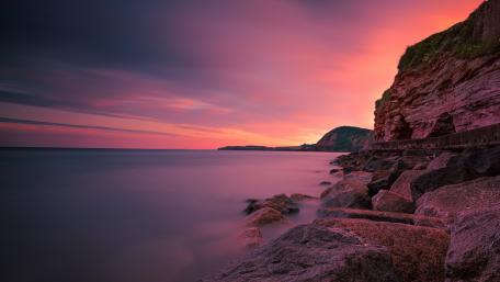 Pink Horizon Over Rocky Coast wallpaper