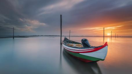 Sunset Boat on Tranquil Lake wallpaper