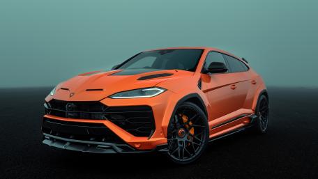 Bold Orange Lamborghini Urus on Misty Asphalt wallpaper