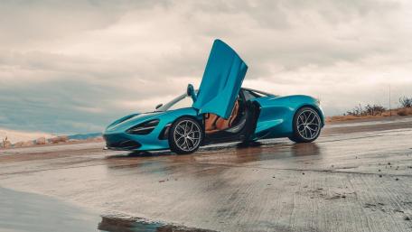 Turquoise McLaren 720s on Rainy Runway wallpaper