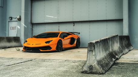 Orange Lamborghini Aventador SVJ Industrial Pose wallpaper