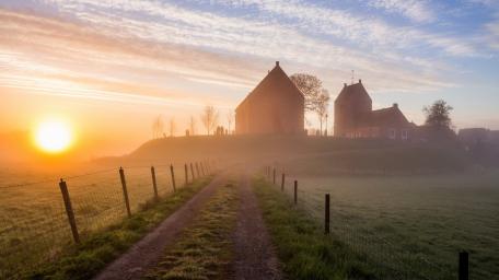 Golden Dawn Over Misty Countryside wallpaper