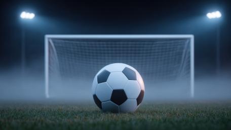 Misty Soccer Goal Under Stadium Lights wallpaper