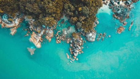 Turquoise Coastline Over Rocky Shores wallpaper