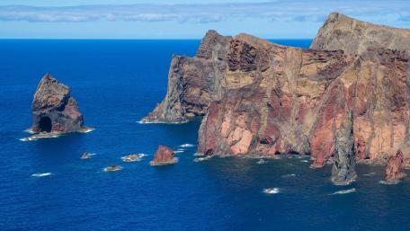 Madeira Cliffs Rising Over Deep Atlantic Blue wallpaper