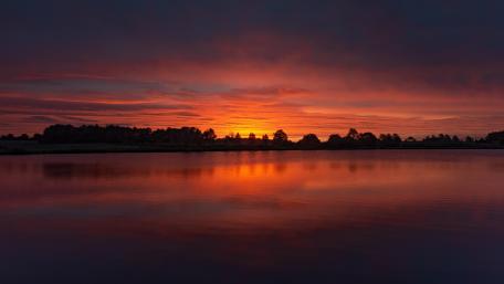 Stunning Orange Sunset Over Serene Lake View wallpaper